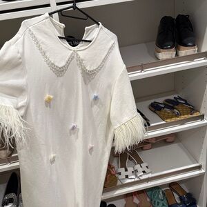 White Dress with Feather Sleeves and Pastel Accents